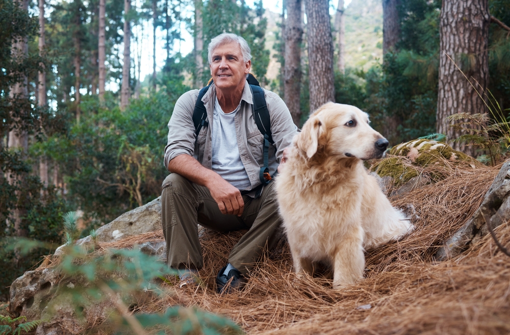 man with dog hiking